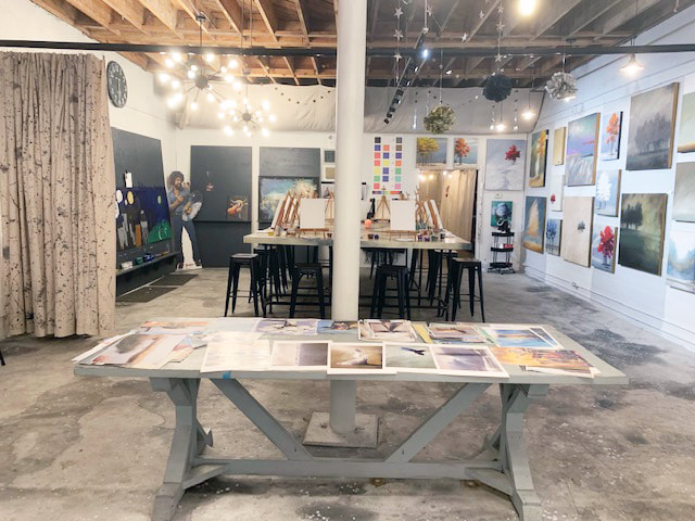 Guests laughing during a private paint party at the Homewood studio