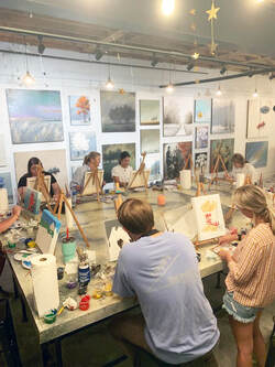 Participant working on individual canvas detail at Thomas Andrew Art.