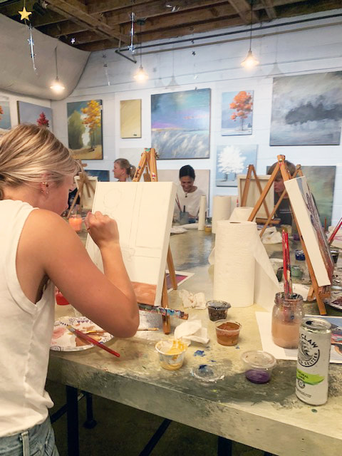 Person adding brushstrokes to their canvas