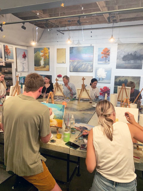 Paint party participants working on their individual canvases