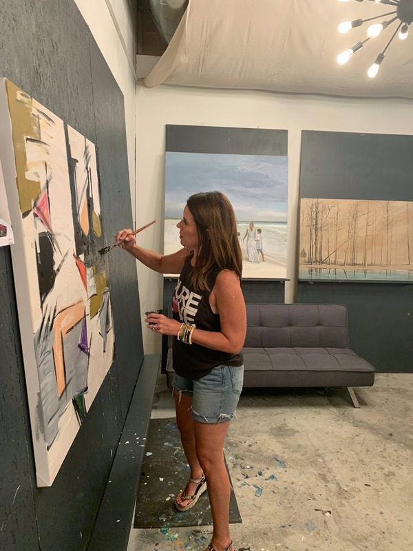 Group of friends laughing and painting together