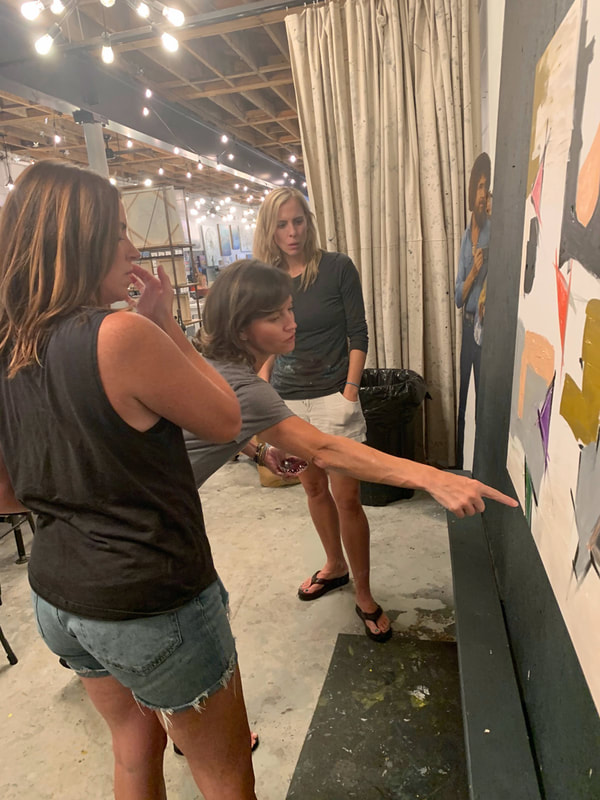 Group working on their individual canvases during a party