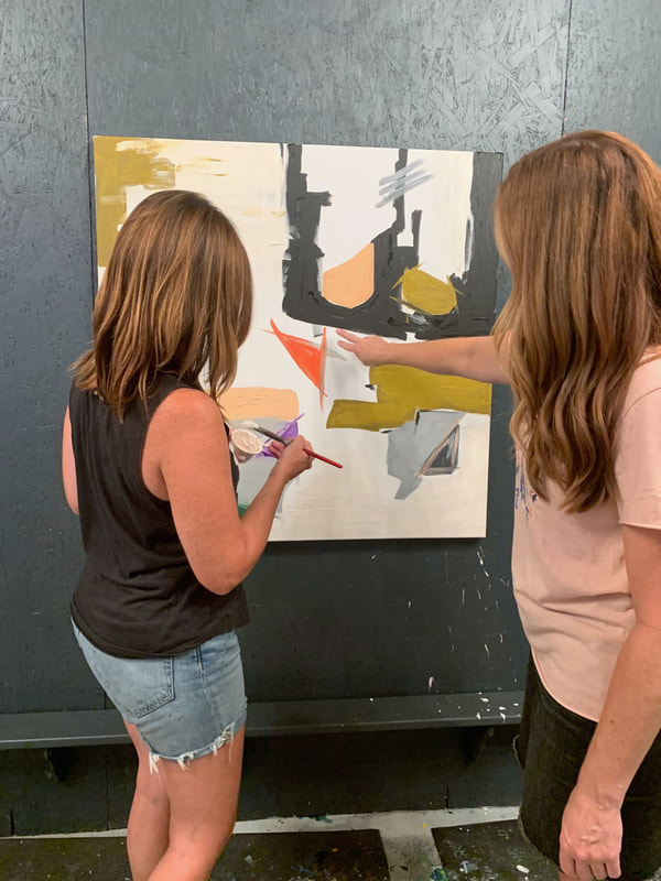 Person carefully painting details on their canvas