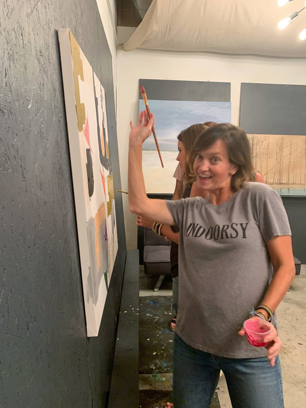 Friends comparing their painted canvases
