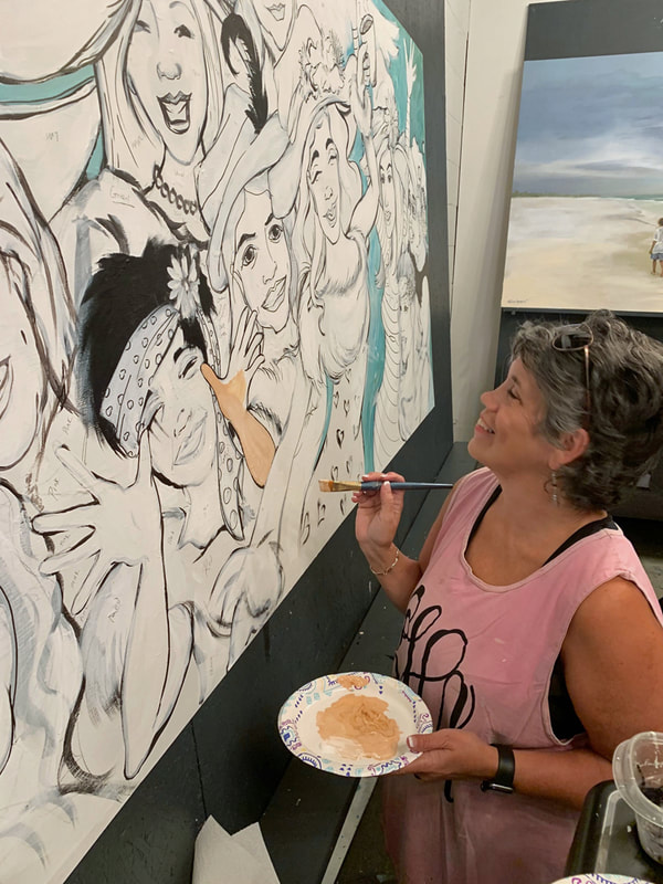 Person adding finishing touches to their completed canvas