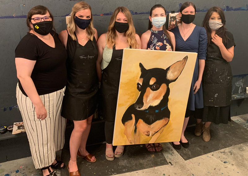 Group of friends at a mural painting event at Thomas Andrew Art studio.